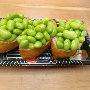 Rice Inside Fried Sweet Tofu Pouch Topped With Edamame
